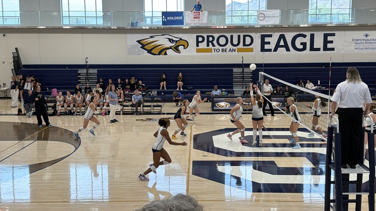 A volleyball player setting the ball in a match