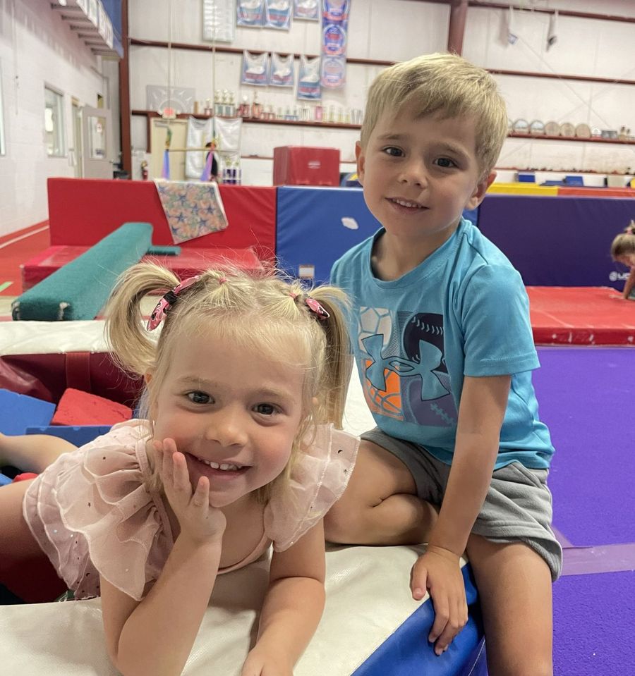 Two kids smiling at open gym